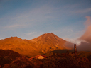 Mount Taranaki with the rising sun light on it.