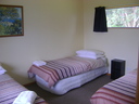 3 single beds in separate room, full bedding included in all Tourist flats