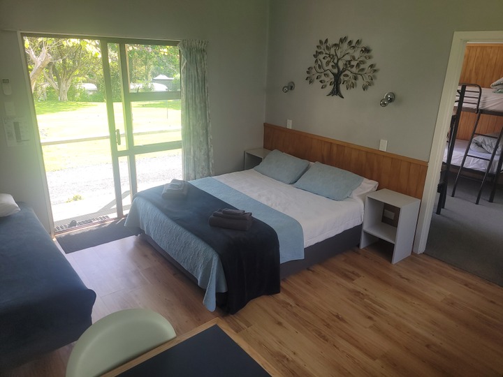 Flat, bunks in second room.  Queen, single and 4 bunks.  Toilet and shower.  Very practical one bedroom units.